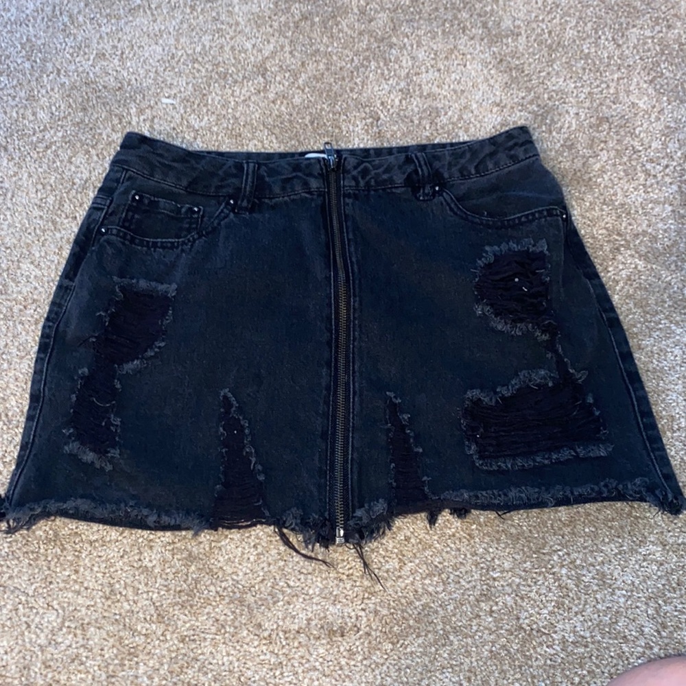 Black jean material skirt, front long zipper supper cute with ruffled edges.